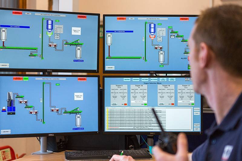 a person sitting at a computer operating the SCADA system at Tilbury Grain Terminal