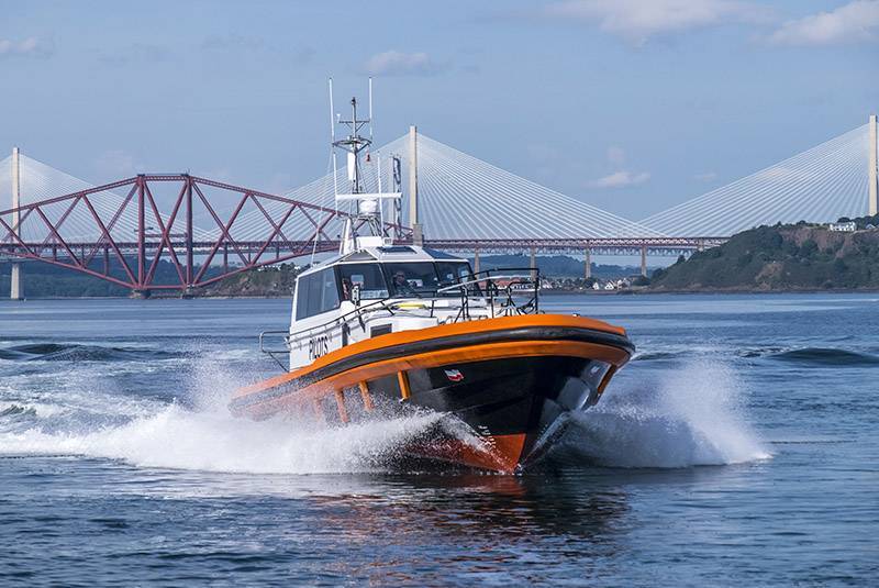 a new Forth Ports Pilot vessel with the Forth Rail Bridge in the background