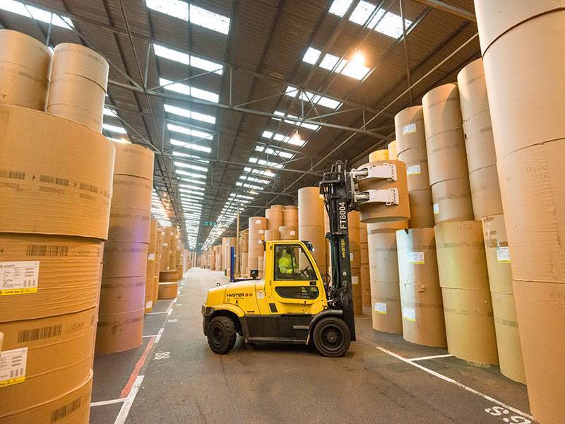 Forklift truck lifting paper roll
